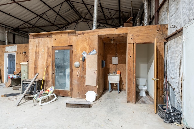 miscellaneous room featuring concrete flooring and vaulted ceiling