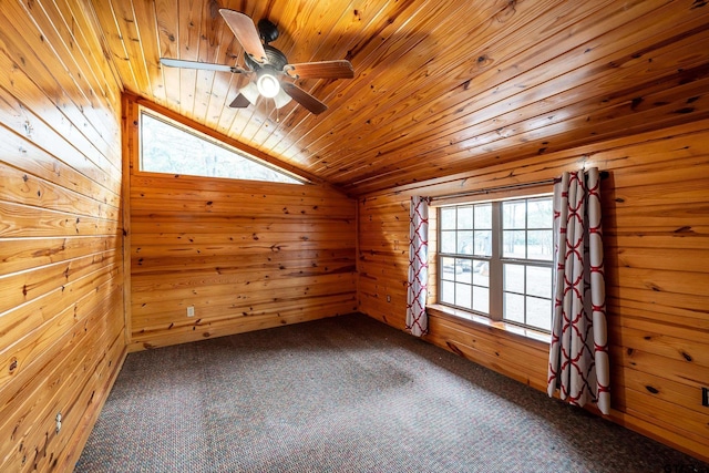 carpeted empty room with wood ceiling, wooden walls, and vaulted ceiling