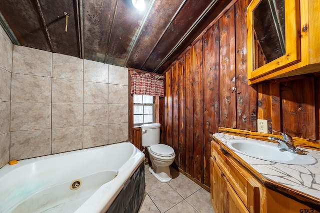 bathroom with tile patterned flooring, vanity, a bath, toilet, and wood walls