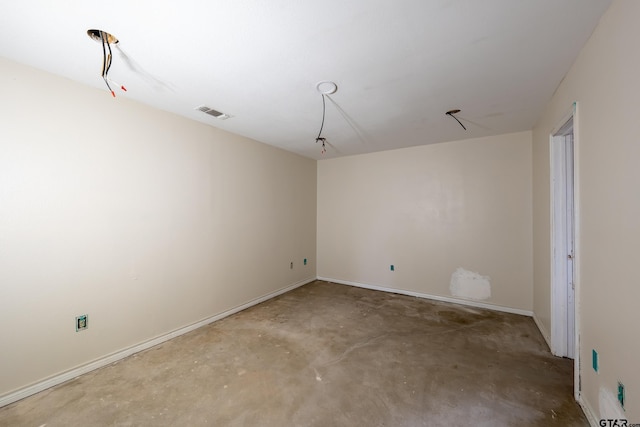 unfurnished room featuring concrete flooring