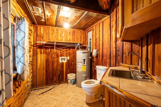 bathroom featuring sink, wood ceiling, electric water heater, tile patterned floors, and wood walls