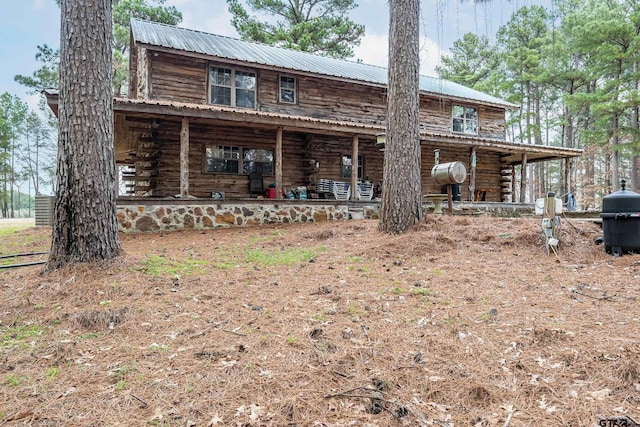 rear view of house featuring a porch