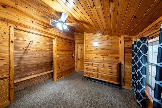 bonus room with wood walls, lofted ceiling, ceiling fan, dark carpet, and wooden ceiling