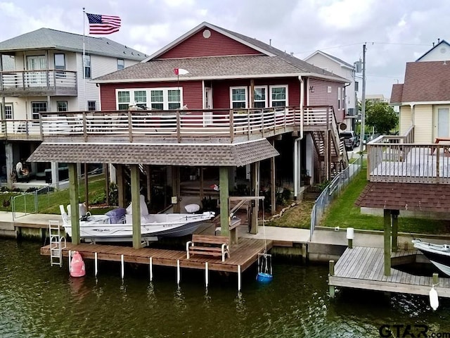 exterior space featuring a deck with water view and a balcony