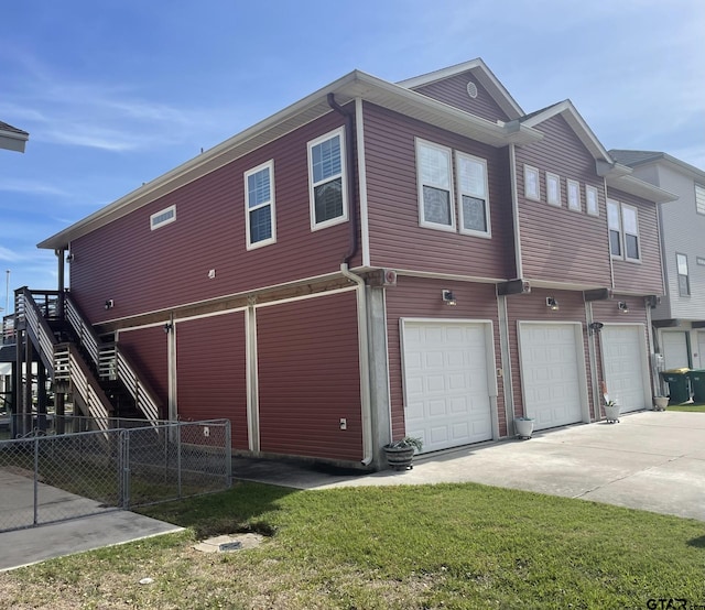 back of property featuring a garage and a yard