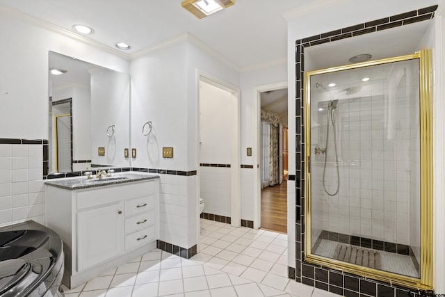 205 Turnberry Cir, Mount Pleasant, TX 75455 - bathroom with tile walls, a stall shower, ornamental molding, toilet, and vanity