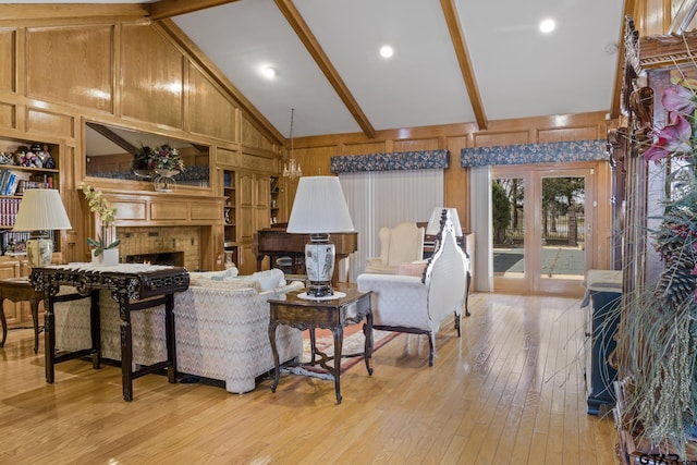 205 Turnberry Cir, Mount Pleasant, TX 75455 - living area with light wood-style flooring, a brick fireplace, beam ceiling, wooden walls, and high vaulted ceiling
