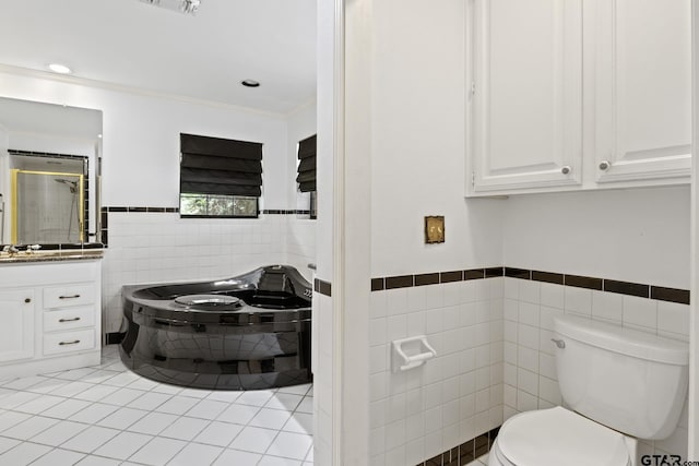 205 Turnberry Cir, Mount Pleasant, TX 75455 - full bath featuring tile walls, toilet, wainscoting, tile patterned floors, and vanity