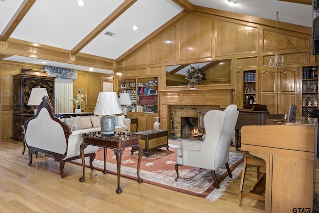 205 Turnberry Cir, Mount Pleasant, TX 75455 - living room featuring wooden walls, high vaulted ceiling, beamed ceiling, light wood-style flooring, and a brick fireplace