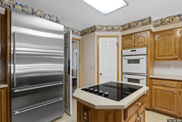 205 Turnberry Cir, Mount Pleasant, TX 75455 - kitchen with black electric cooktop, high quality fridge, double oven, light tile patterned floors, and light countertops
