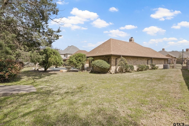 205 Turnberry Cir, Mount Pleasant, TX 75455 - view of side of property with a chimney, brick siding, and a gate