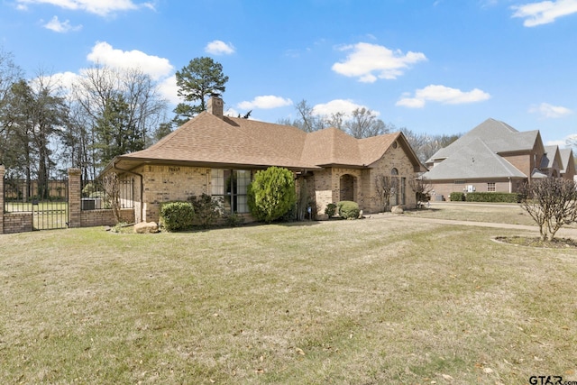 205 Turnberry Cir, Mount Pleasant, TX 75455 - view of front facade featuring brick siding, a chimney, roof with shingles, and a gate
