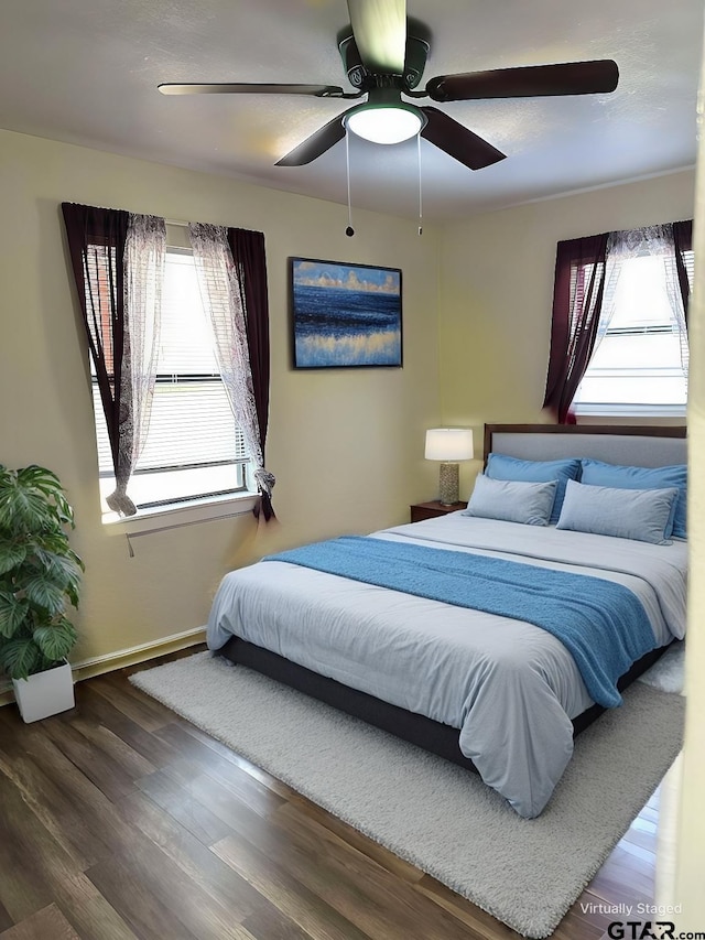 bedroom with hardwood / wood-style floors and ceiling fan