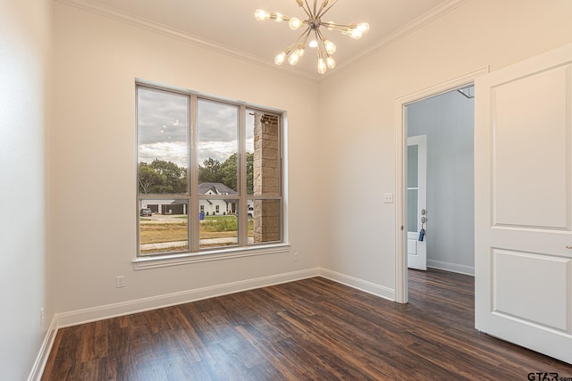 spare room featuring ornamental molding, dark wood-type flooring, and a chandelier