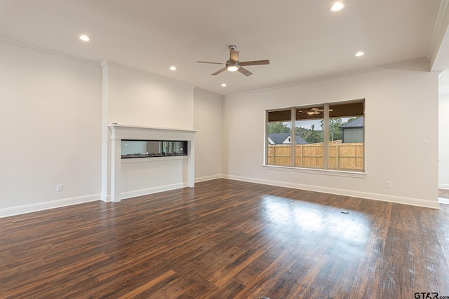 unfurnished living room with ceiling fan, dark hardwood / wood-style floors, and ornamental molding