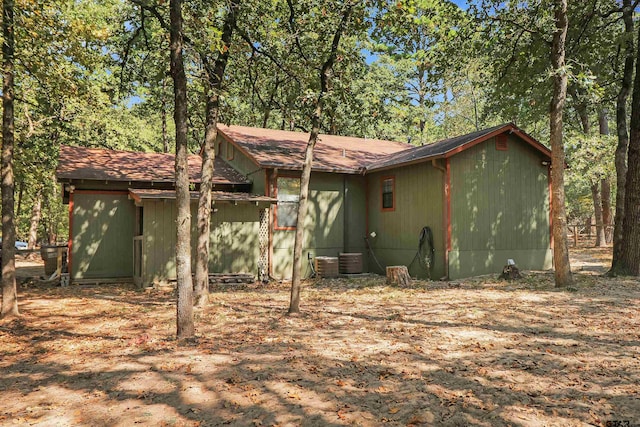 rear view of property with central AC