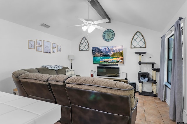 tiled living room with ceiling fan and lofted ceiling with beams