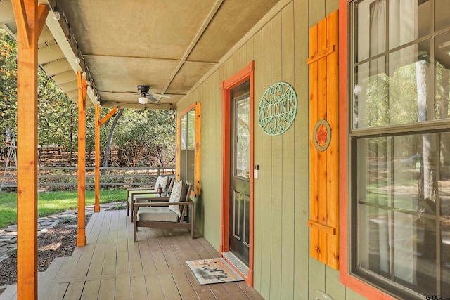 deck featuring covered porch and ceiling fan