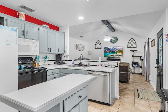 kitchen with sink, white appliances, a kitchen island, lofted ceiling with beams, and light tile patterned flooring