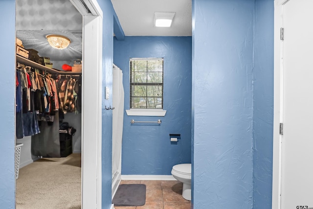 bathroom with tile patterned flooring and toilet