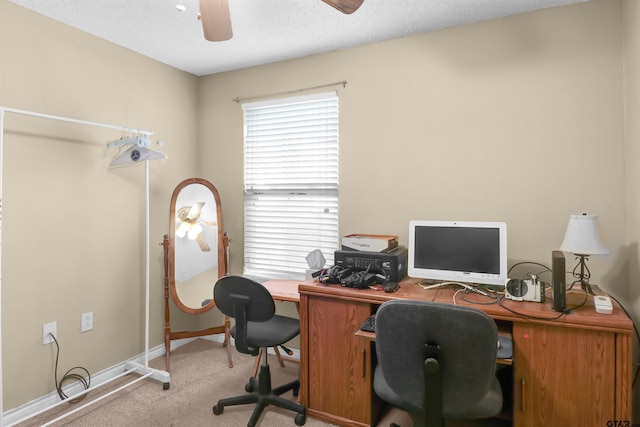 carpeted office with a textured ceiling and ceiling fan