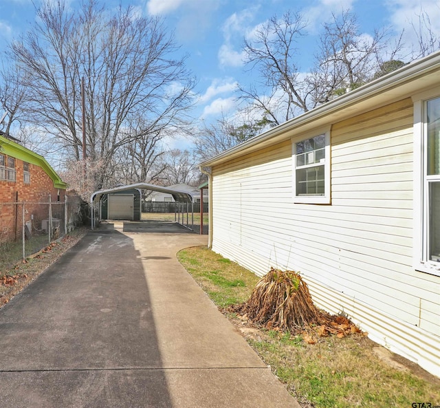 view of home's exterior with a carport and a garage