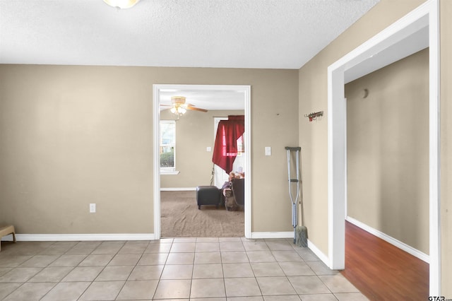 interior space featuring light tile patterned flooring and a textured ceiling