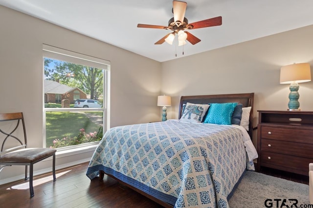 bedroom with baseboards, ceiling fan, and wood finished floors