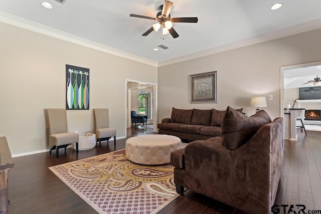 living area featuring crown molding, ceiling fan, dark wood-style floors, and visible vents