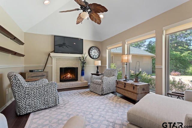 living room with wood finished floors, a fireplace, recessed lighting, a ceiling fan, and vaulted ceiling