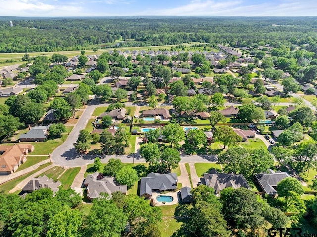 birds eye view of property featuring a view of trees and a residential view