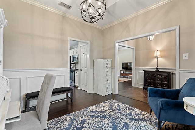 office space with visible vents, a wainscoted wall, a chandelier, ornamental molding, and a decorative wall