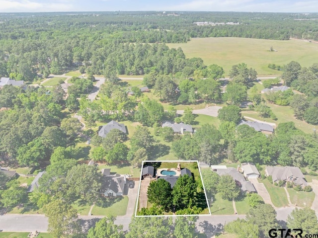 bird's eye view featuring a residential view and a wooded view