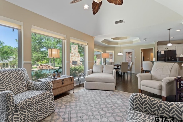 living area featuring a ceiling fan, recessed lighting, wood finished floors, visible vents, and ornamental molding