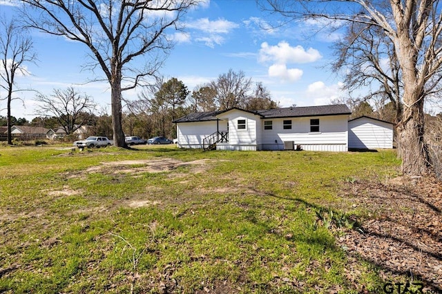 back of house with a yard