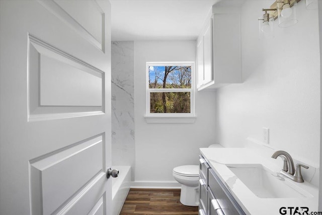 full bath featuring baseboards, toilet, wood finished floors, and vanity