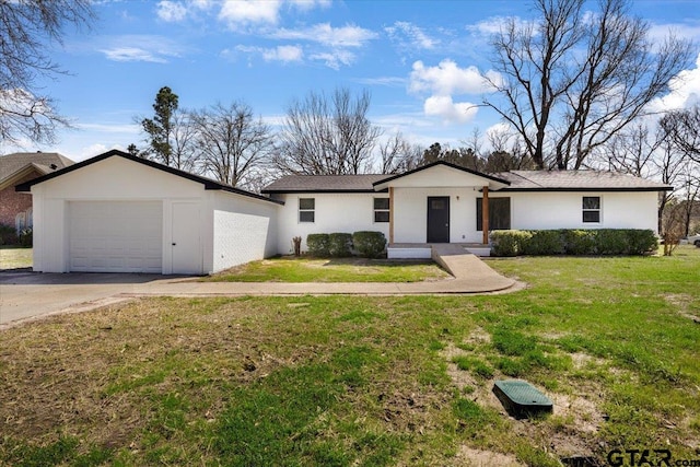 ranch-style house featuring driveway, an attached garage, and a front yard