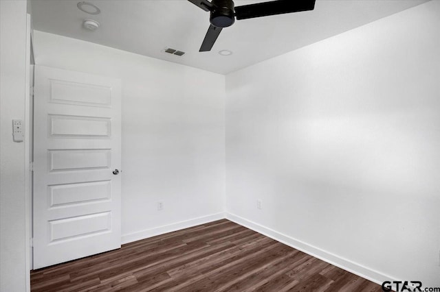 unfurnished room featuring a ceiling fan, visible vents, dark wood-style floors, and baseboards