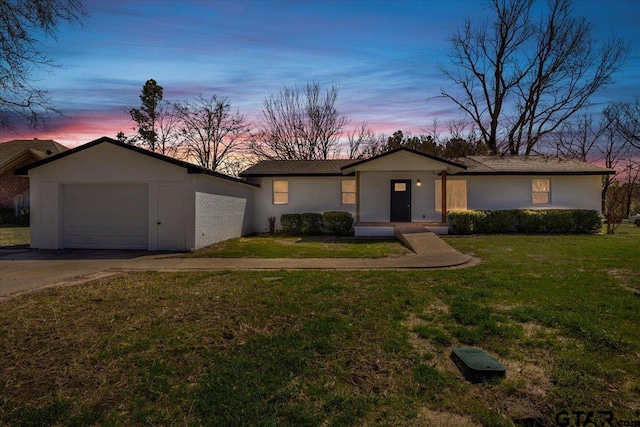 view of front facade with a garage, driveway, and a front lawn