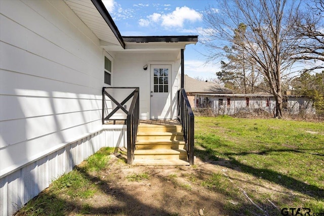 entrance to property with a lawn