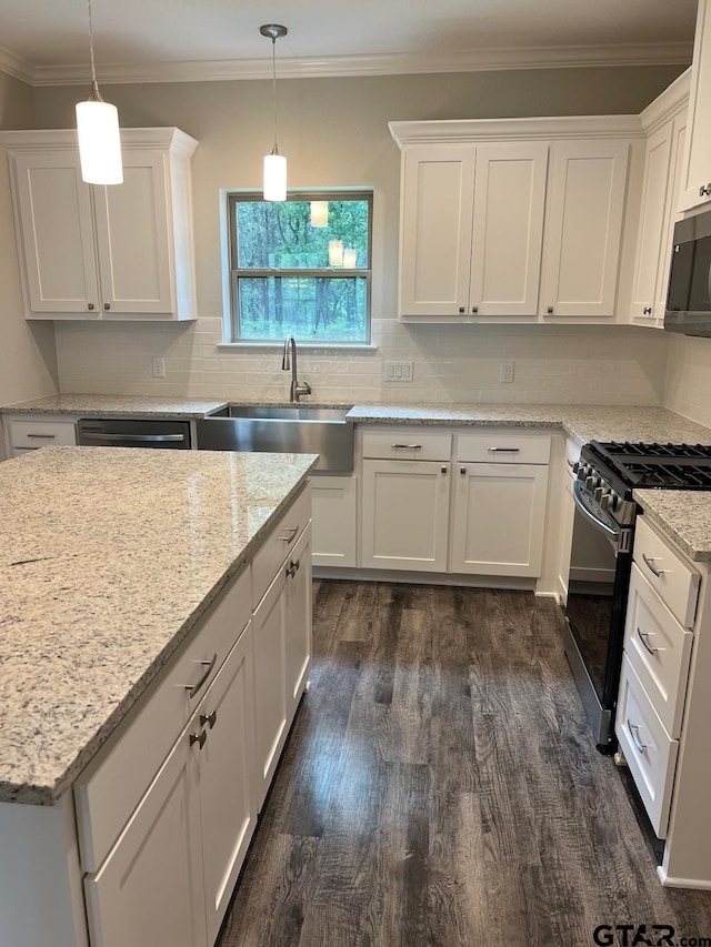 kitchen featuring dark wood-type flooring, white cabinetry, pendant lighting, and stainless steel appliances