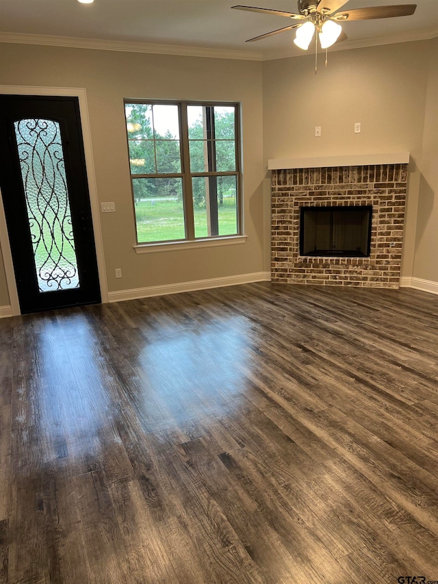 unfurnished living room with ornamental molding, a fireplace, and dark wood-type flooring