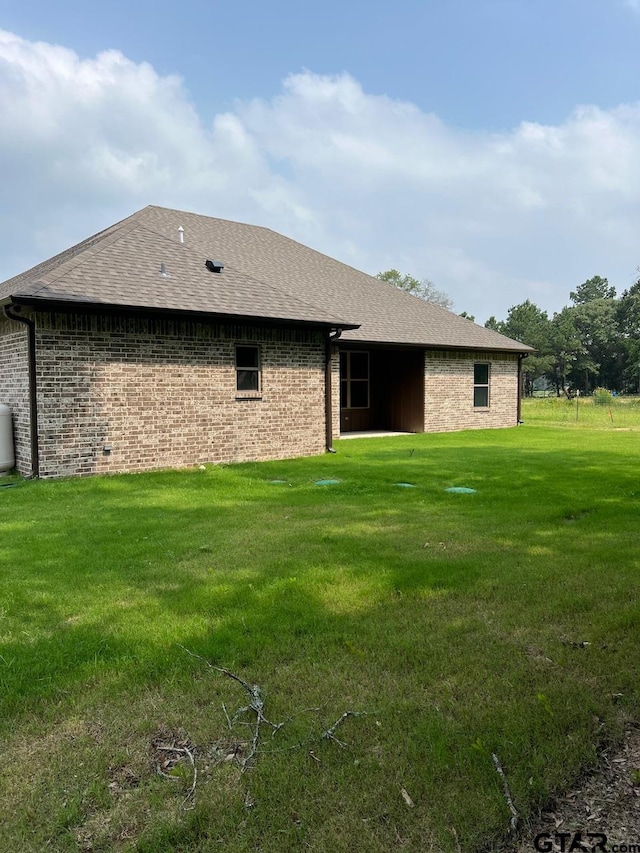 back of house featuring a lawn