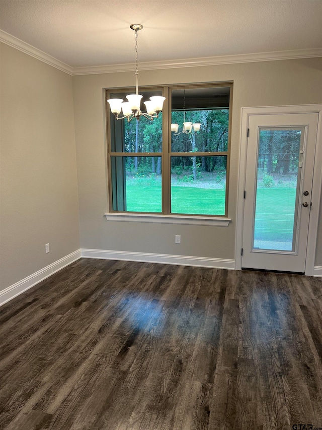 unfurnished dining area with dark wood-type flooring, a notable chandelier, and crown molding