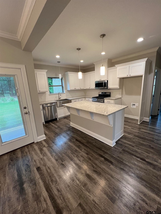 kitchen with white cabinetry, stainless steel appliances, dark wood-type flooring, and a center island