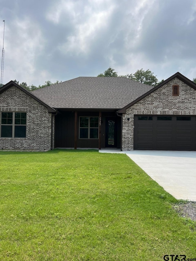 ranch-style home featuring a garage and a front yard