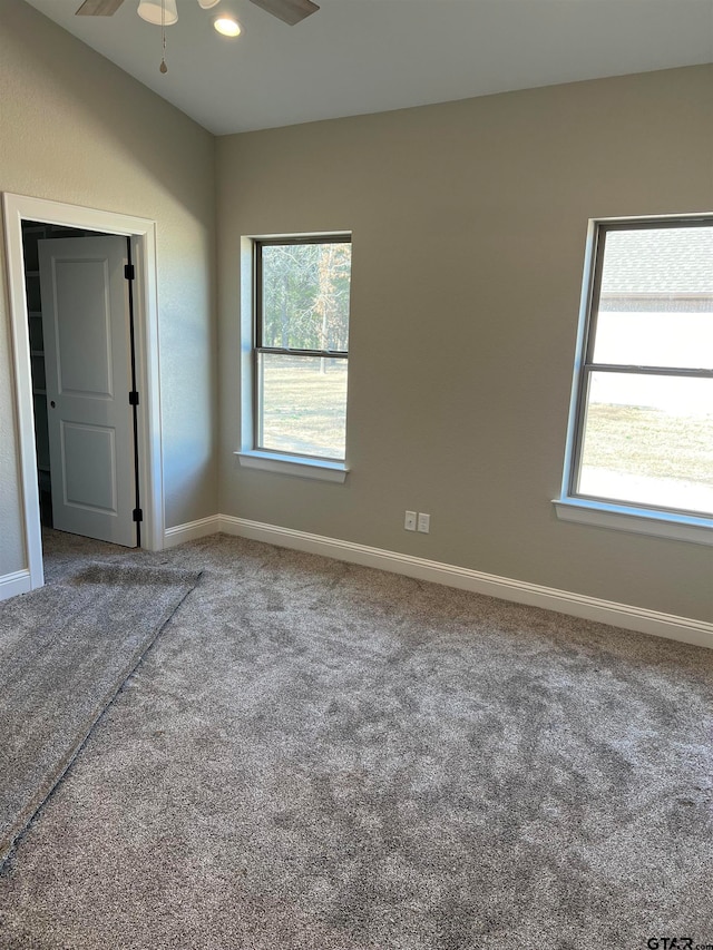 carpeted empty room featuring ceiling fan