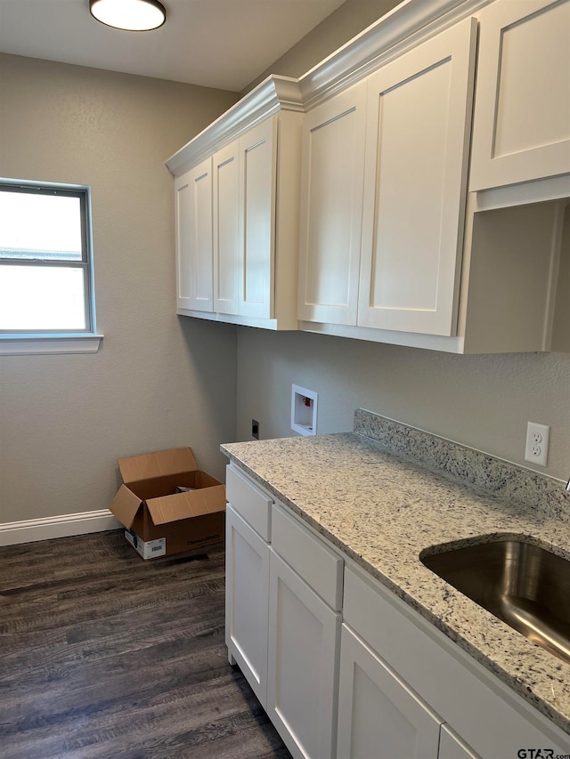 clothes washing area featuring hookup for an electric dryer, washer hookup, dark hardwood / wood-style floors, cabinets, and sink