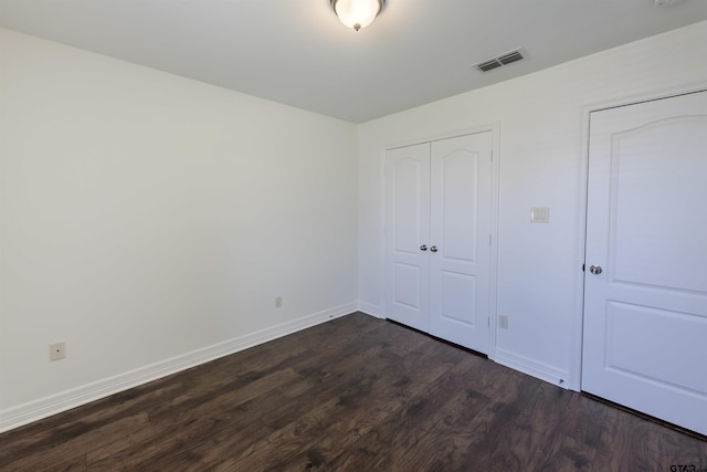 2056 Balsam Gap, Tyler, TX 75703 - unfurnished bedroom featuring dark wood-style floors, baseboards, visible vents, and a closet