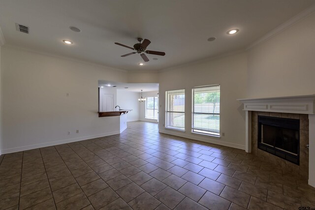 2056 Balsam Gap, Tyler, TX 75703 - unfurnished living room featuring visible vents, ornamental molding, and ceiling fan with notable chandelier